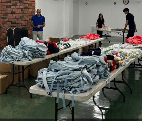 Comfort Cases partnered with Women of the NFL, who
help pack 200 backpacks.