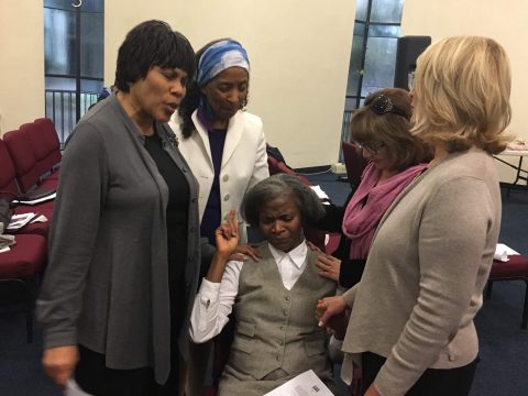 Dorothy Means, Pacific Union Women's Ministry leader; Akivah Northern, member of SCC Prayer Ministry team; Alma Wesley, Vallejo Drive church member; and Janet Lui, SCC Prayer Ministry coordinator, pray over Pastor Mabel Duncan, Sunland-Tujunga church, and her family. Photo by Lauren Armstrong