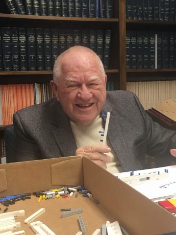 Bob Dennis, EdD, helped Education staff members prepare the Legos prior to the Robotics Tournament. Photo by Rachel Logan