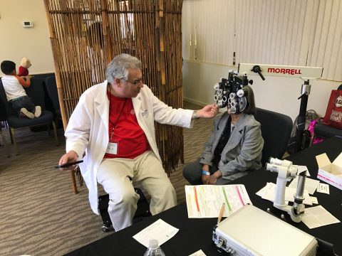 Martin Hyman, MD, examines a patient’s vision. The patient was one of 146 patients who received vision care and prescription glasses, as needed. Photo by John Jenson