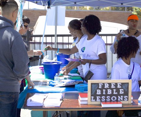 At one canopied table, visitors registered and could receive free Bible lessons. Photo by Clarence Brown