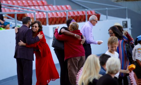 Attendees get up to hug one another and affirm their unity in Christ as the choir sings “Make Us One,” following Salazar’s appeal. Photo by Donald McPhaull