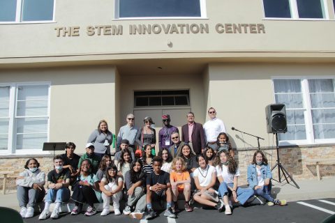 Students, faculty, staff, alumni, benefactors, and representatives from SCC and AH Glendale pose in front of the STEM Innovation Center before touring the space.