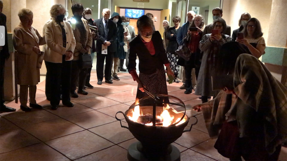 Following remarks from each of the SCC executive officers, SCC West Region Director Greg Hoenes, and former Tehachapi pastors Erwin Joham and Laurie, the congregation gathered to burn the mortgage papers. Karen Towns, church treasurer, opens the cover while Barbara Hoyt, former church treasurer, places the document in the fire.