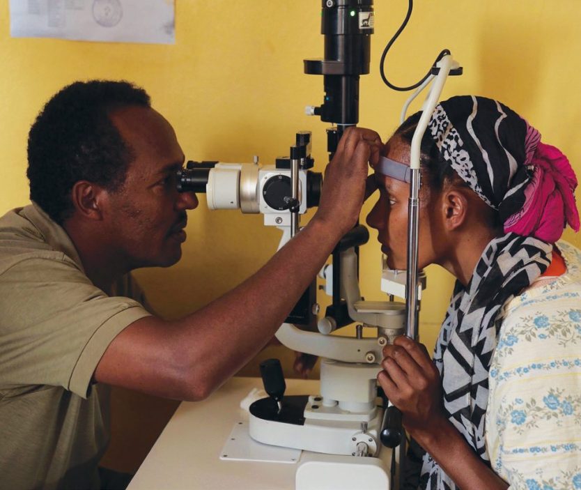 Bora examines Lalise, a 23-year-old mother who was blind and had never seen her four-month-old infant.