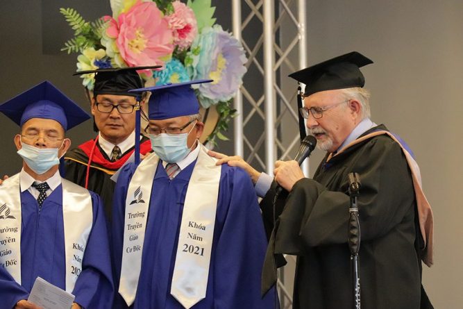 Cress prays over the graduating class.