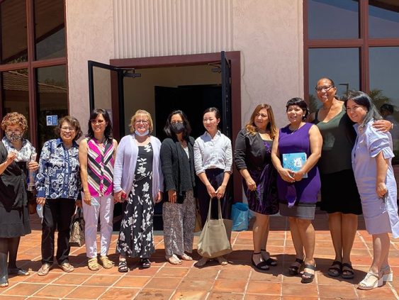 While visiting Rolling Hills church this summer, Mira (third from right) stands with her prayer warriors, holding the Bible they gave her.