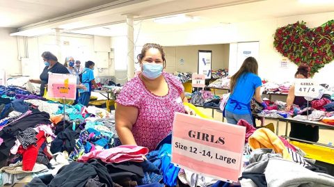 One shopper chooses free clothing items for her family.