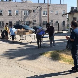 Those waiting in line to pick up food from the food pantry practice social distancing.