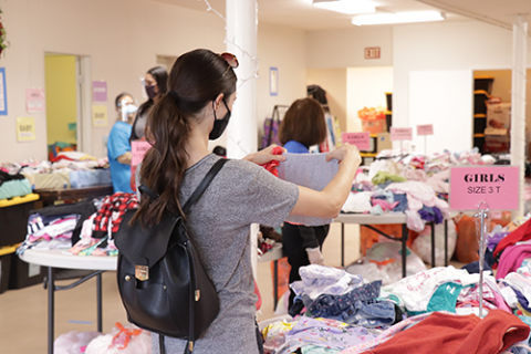 One attendee shops for clothes for her young daughter at Sunland-Tujunga church’s God’s Closet event.