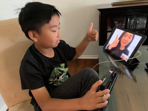 Liam checks in with his fourth-grade class with a “thumbs up.”