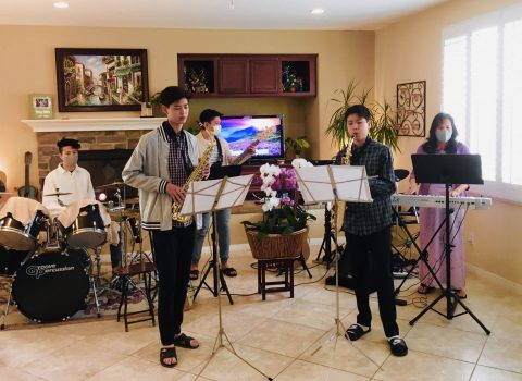 The Nguyen family gets together for song service for an online worship service.