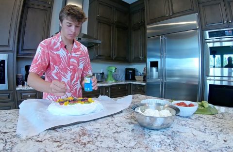 Swenson tops the pavlova with fruit.