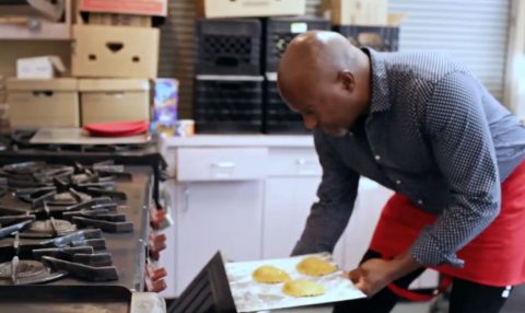 Fred Jean-Marie places the Martinique empanadas in the oven to bake for about 20 minutes.