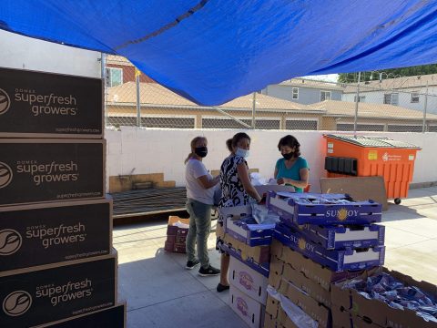 Lynwood church volunteers prepare items for distribution.