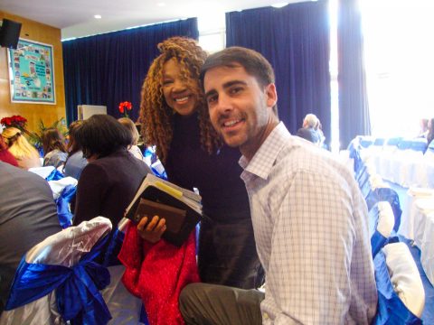 Judith Miranda hugs Andy Stuart, a medical supplier she had invited from her workplace. This was his first time in an Adventist church. Photos by Connie Jeffery.