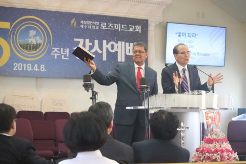 Salazar (left) delivers a message as Lee (right) interprets.