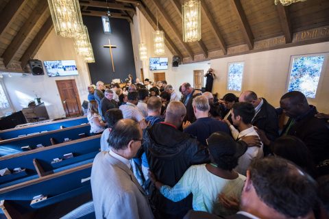 GC, NAD, and PUC officials lay hands on the members of El Monte Vietnamese church in prayer.