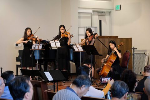 A string quartet from Chino Valley Chinese church accompanies the praise team as they sing “How Great Thou Art.”