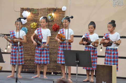 Participants of all ages showcase their musical talents during the anniversary celebration. CFC youth play “Bahay Kubo,” a Filipino folk song, on ukuleles.