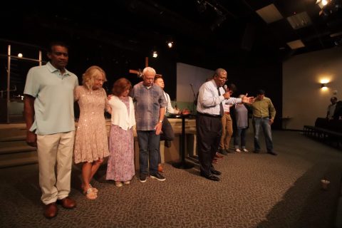 Lee prays over the leadership and members of the congregation.