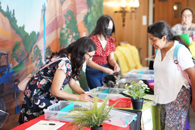 An attendee from West region checks in. Registration was organized by region for an easy check-in process.