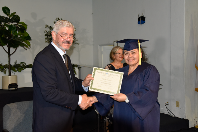 Norton (left) hands a certificate to Maribel Arteaga (right), member of La Voz Sylmar Spanish church. Of the 80 graduates, 15 were women