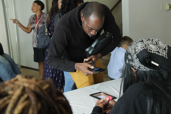 Attendees scan QR codes at the registration table. 