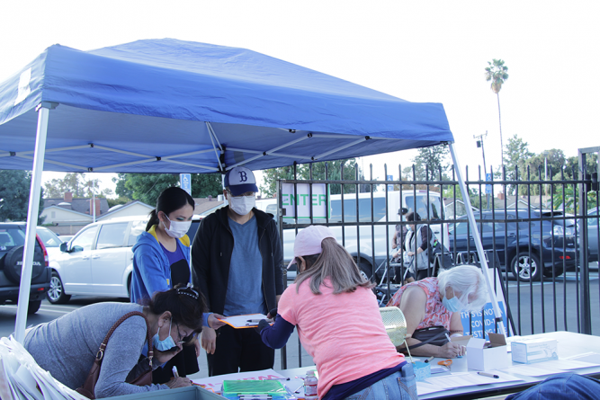 At the registration booth, attendees sign in to receive canvas tote bags from ACS and raffle tickets to win prizes.