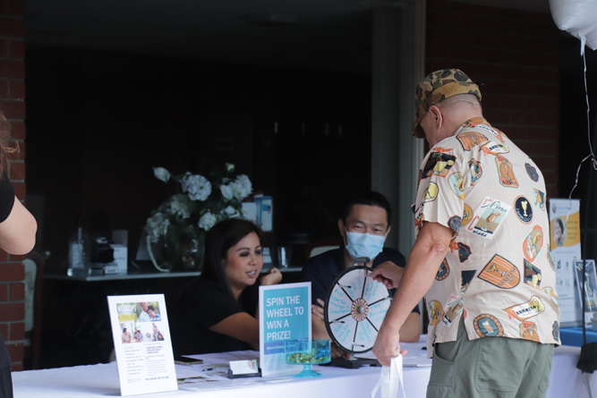 An attendee spins the wheel to win a prize from Britton Chiropractic in Temple City. 