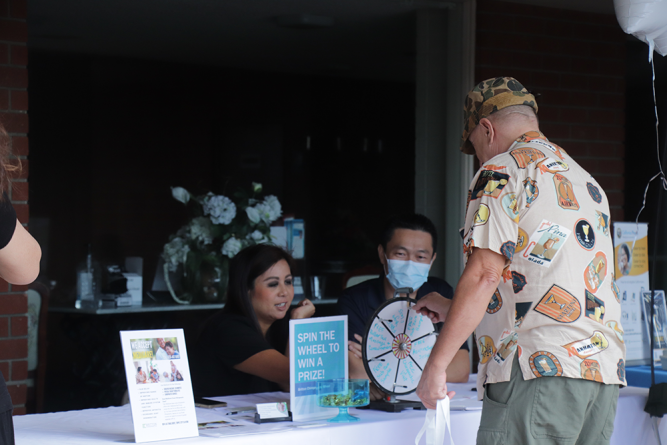 An attendee spins the wheel to win a prize from Britton Chiropractic in Temple City.