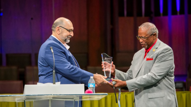 At the 2022 Hospital Sabbath event, James Patterson is awarded the annual Christian Service Award from Adventist Health White Memorial by AHWM president John Raffoul.