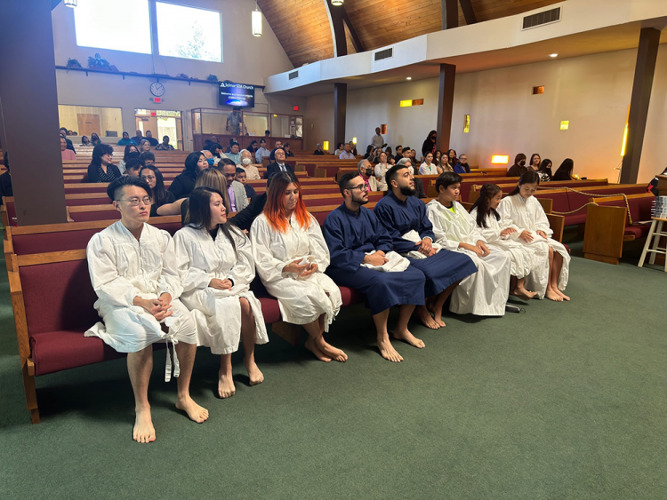 Candidates are seated before baptisms begin. Additional robes were borrowed from Living Stones church.