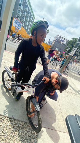 A young biker gets his tires pumped at the Hollywood church station.