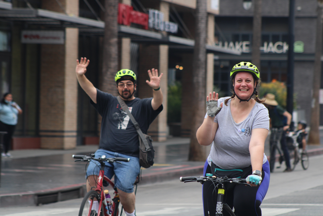 Alburn (left) and Kelsy (right) bike through the open Hollywood boulevard.