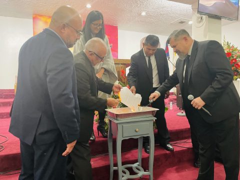 (Left to right) Culver City Spanish church elders Felipe Carrillo and Luis Cortes, SCC Treasurer/CFO Kathleen V. Diaz, first elder Alfonso Lara, church elder Jairo Saravia, and pastor Giddell Garcia perform the mortgage burning ceremony.