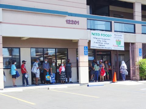 Members of the community line up outside to enter the food pantry.