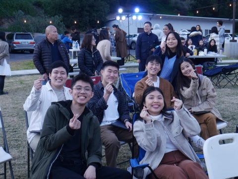 A group of friends pose together for a picture, excited for the program to start.