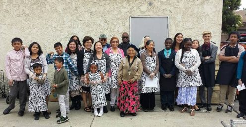 Food bank volunteers— including church members and nonmembers— don smiles and matching aprons. Photo provided by Iki Taimi.