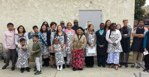 Food bank volunteers—including church members and nonmembers—don smiles and matching aprons. Photo provided by Iki Taimi.