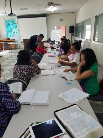 Pastor Carlos Acosta, senior pastor, Spanish American church, taught the fourth seminar. Here, students are working on an assignment, as Pastor Acosta assists/ Photo courtesy of CARSON SDA CHURCH Facebook page