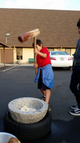 One student participates in the cultural tradition of “Mochi Pounding.” Photo provided by Chris Ishii