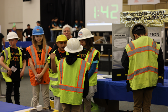 Team Gold from Ridgecrest Adventist Elementary School dress up for their presentation. In addition to designing and building a robot for the challenge, each team must research a real-world problem and present their solution to judges.