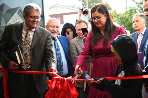 A ribbon-cutting ceremony initiated the church status celebration. Diaz (right) cuts the ribbon as Salazar (left) holds it in place.