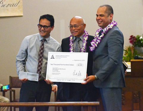 Orville Ortiz, SCC treasurer/CFO (right), presents a check to church treasurer Gideon Ondap (left) and Pastor Romeo Canales (middle). The money will be used to support the church’s evangelistic efforts.