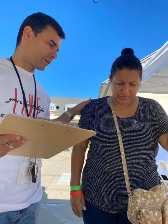 Each of the guests had the opportunity to receive multiple services throughout each day. There, Jimenez (L) provides spiritual encouragement for a patient.