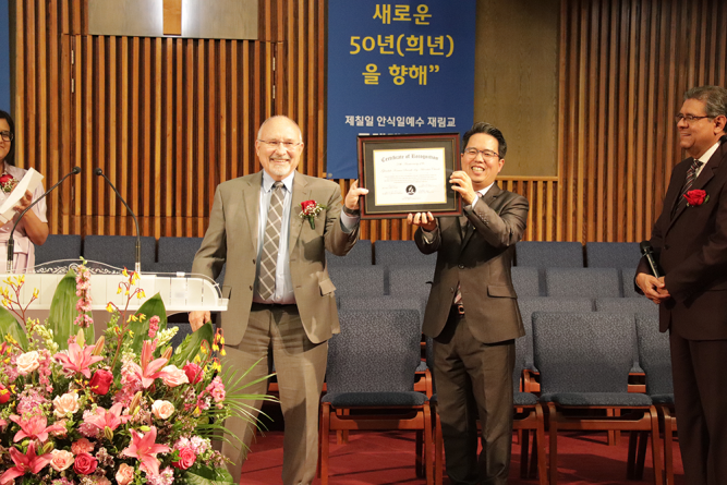 Cress presents the congregation with a certificate to commemorate the 50th anniversary.