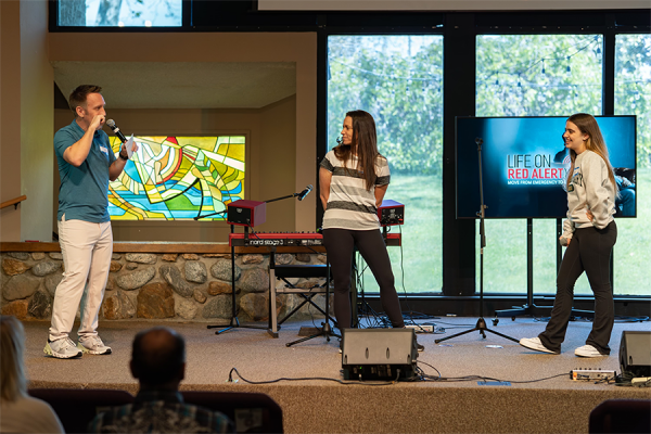 Cress (left) leads improv games to energize attendees at the start of the event with the help of his wife and
daughter.