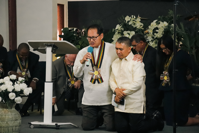 Vinh Nguyen, SCC Asian- Pacific Region director, offers the dedication prayer over the newly organized company.