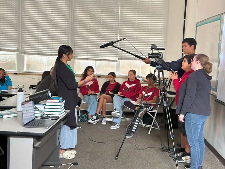 Michelle Noland (right), SCC associate director for media production, demonstrates basic camera and boom mic operation during a film class.